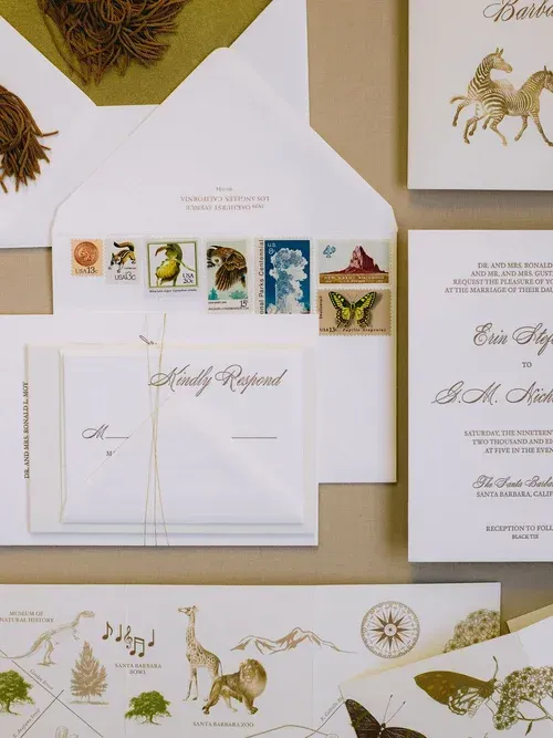 Elegant wedding invitation suite with white and gold botanical and deer designs