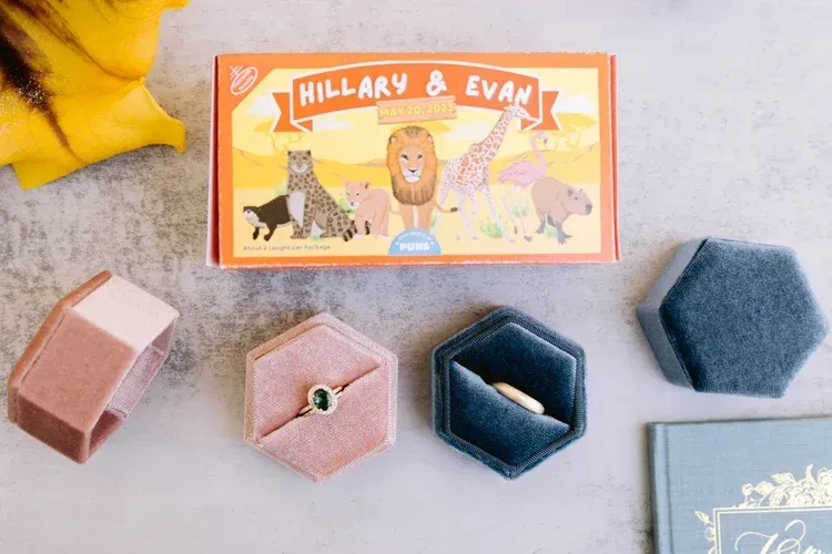 Assorted fabric storage boxes and a “Hillary & Evan” box on a light surface