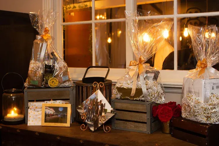Festive gift baskets and holiday decor on a table by a lit window