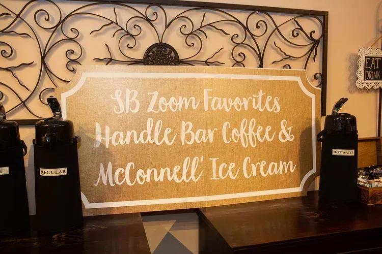 SJB Zoom favorites handle bar coffee and McConnell Ice Cream sign on a café counter