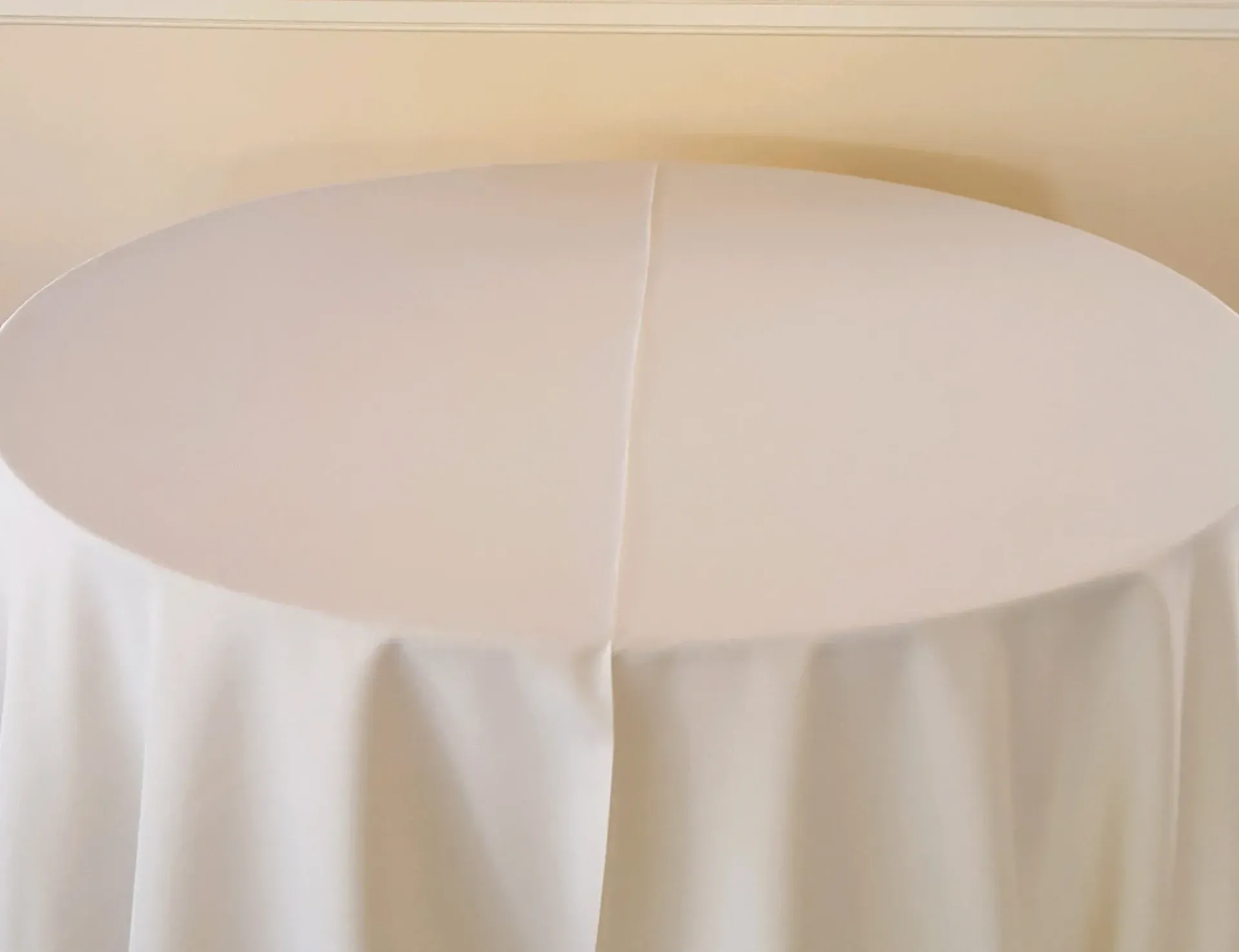 Round table covered with a white tablecloth
