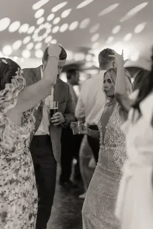 Guests dancing at a lively indoor party under patterned lights