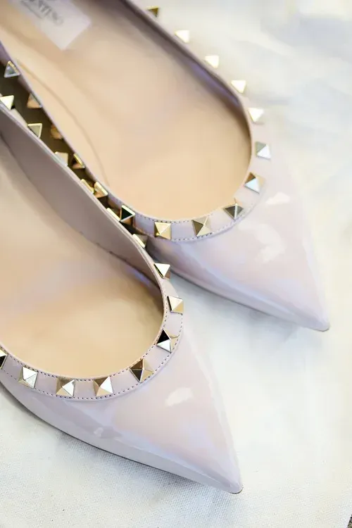 Pale lavender pointed flats with silver studs along the opening, shown side by side.
