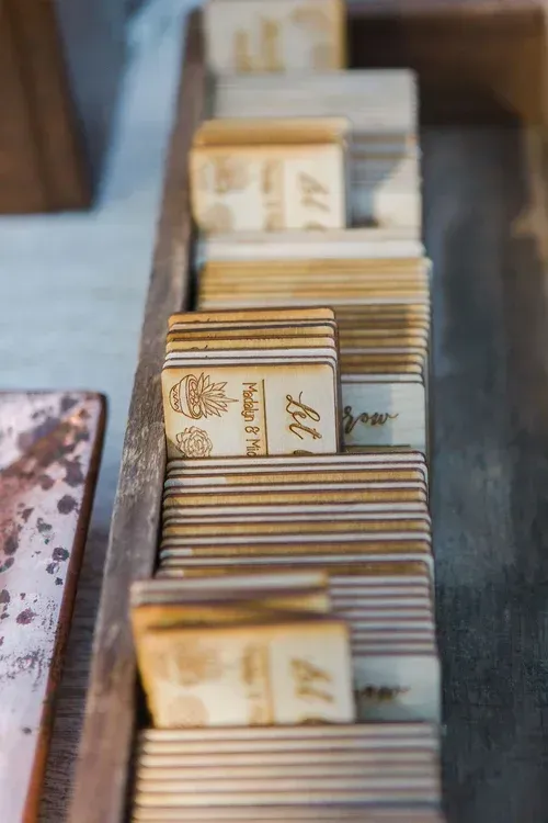 Wooden blocks stacked in a narrow tray, with engraved markings on each piece