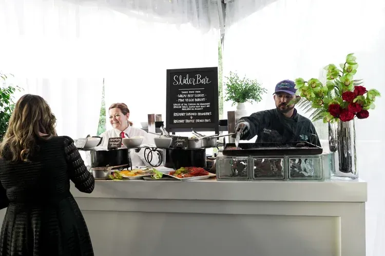 Indoor café counter with staff serving drinks and flowers on display