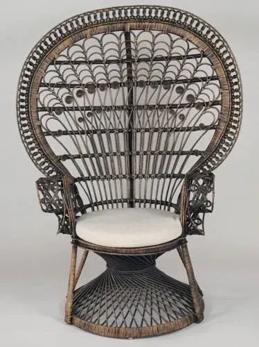 Ornate black wrought-iron peacock chair with white seat and fan-shaped backrest