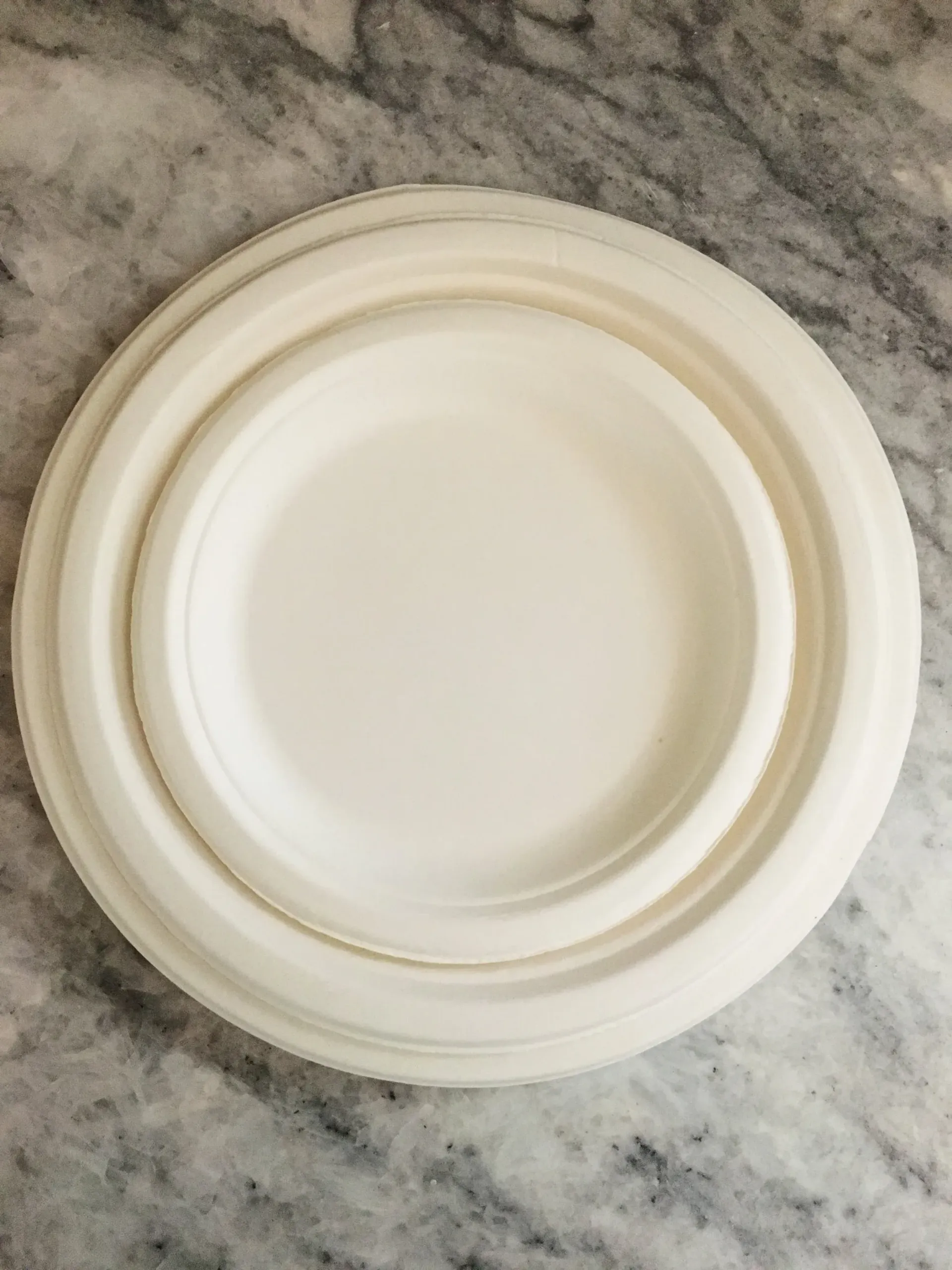 White round plastic lid on a gray marble surface