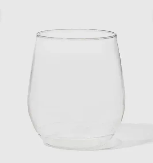 Clear empty glass tumbler on a light background