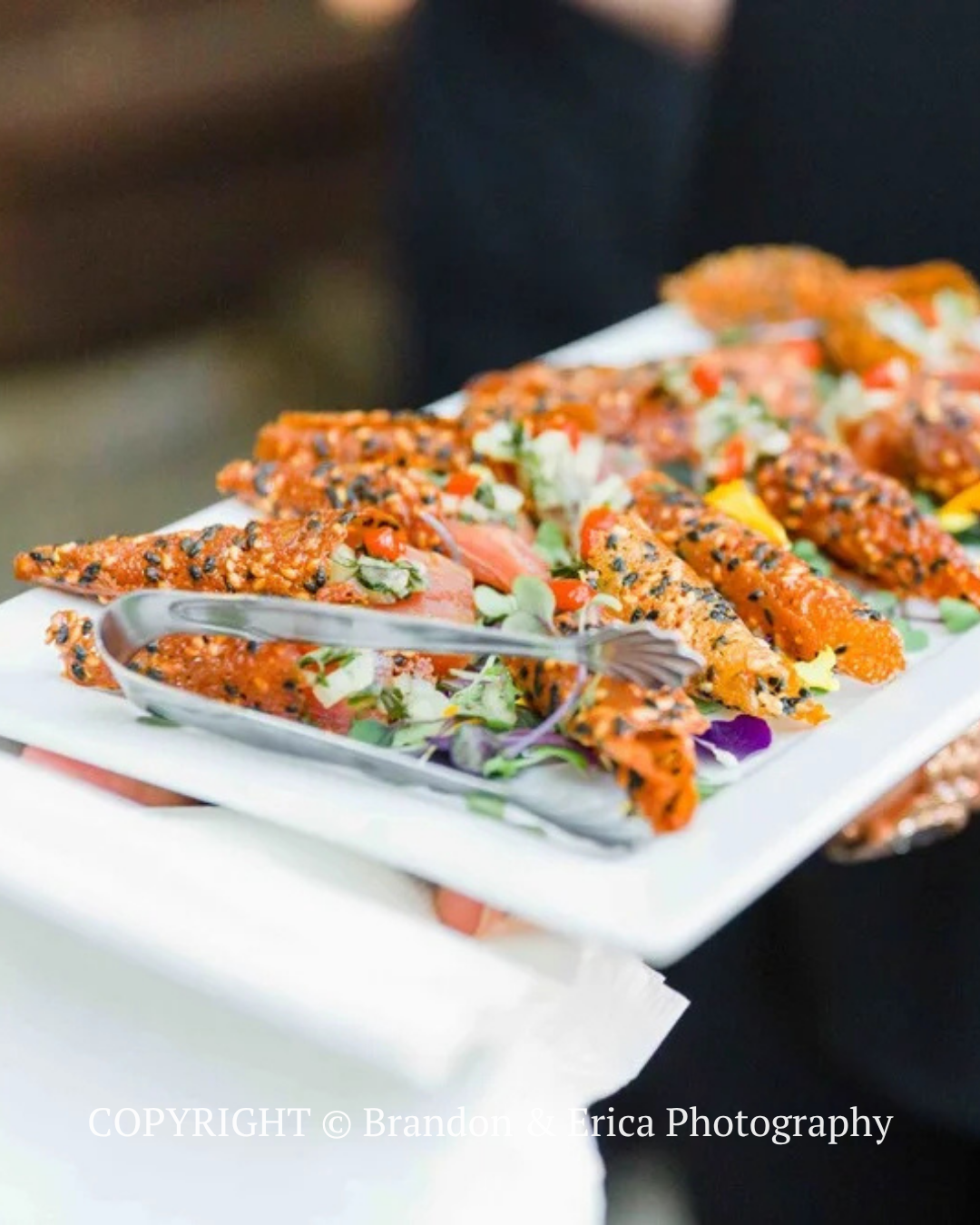 Plated tacos topped with salsa and herbs, served with a fork on a white platter