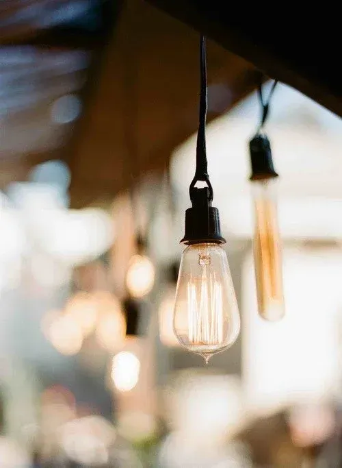 Warm hanging Edison bulbs in a softly blurred indoor setting