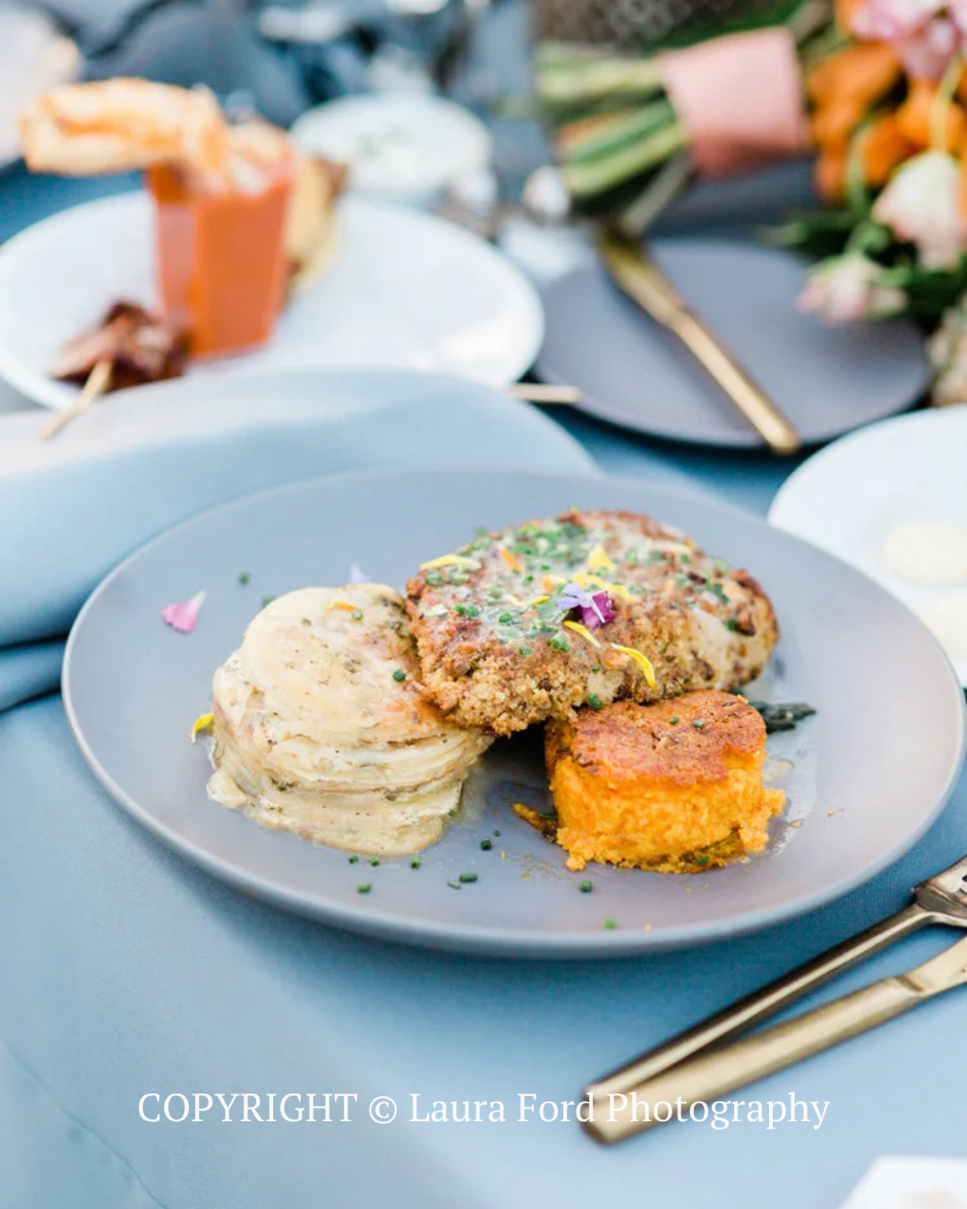 Plated gourmet meal with mashed potatoes and croquette on a blue table setting