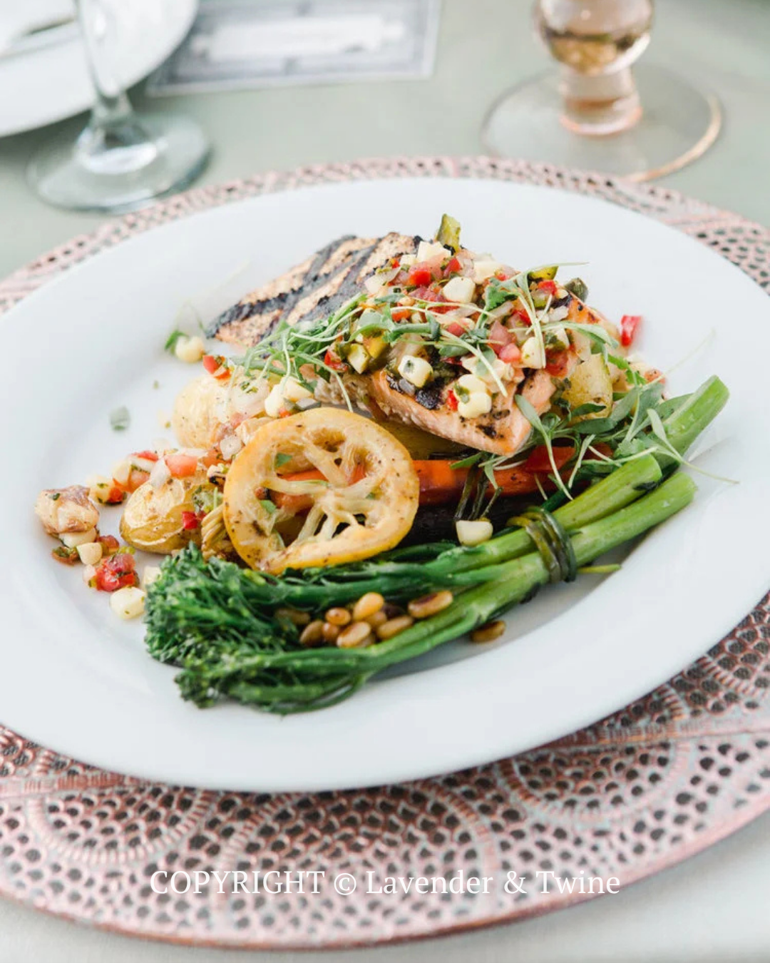 Plated grilled fish with vegetables and herbs on a white dinner plate