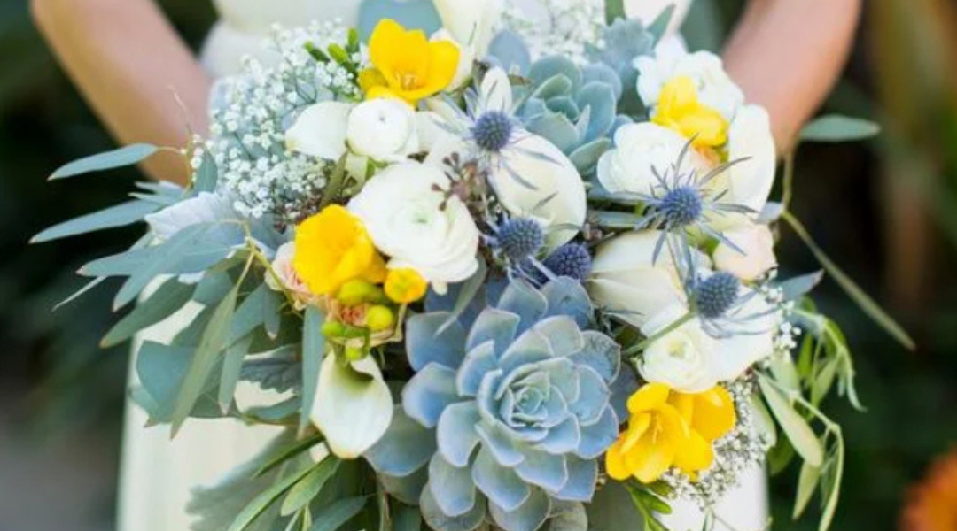 Blue and yellow bouquet with white flowers and green foliage