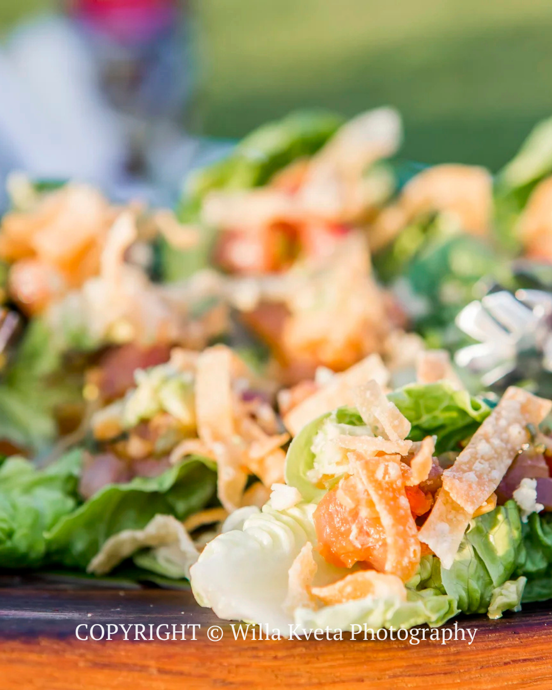 Fresh green salad with carrots, cabbage, and dressing on a plate
