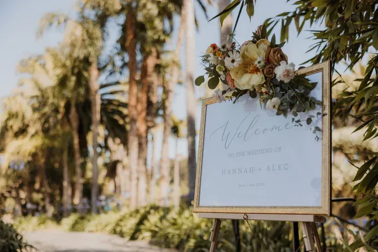 Welcome sign with flowers in a sunny outdoor garden setting