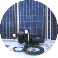 A swimming pool pump is sitting in front of a solar panel