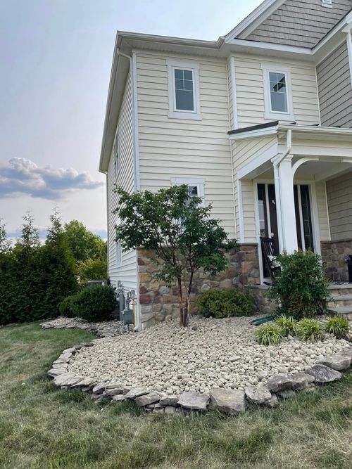 A Large White House With A Tree In Front Of It - Perry Hall, MD - Oakwood Landscaping LLC