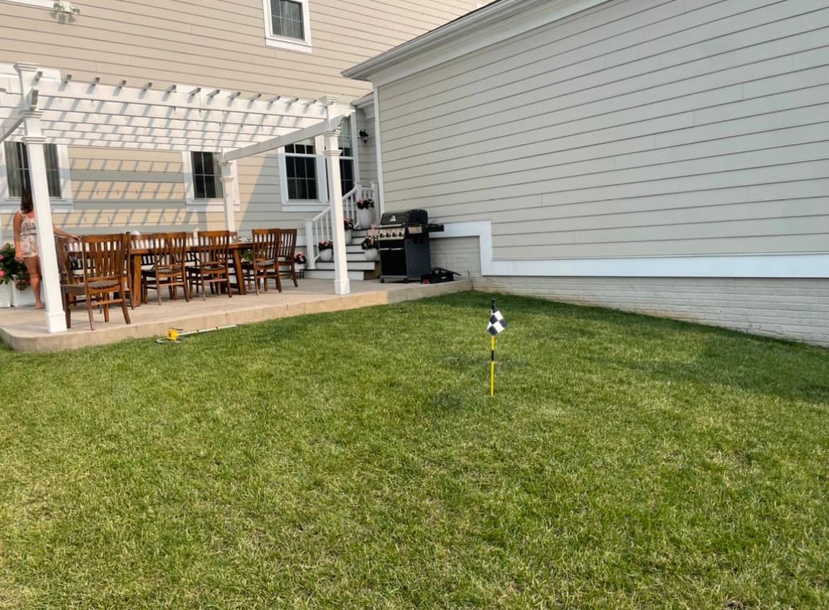 A Backyard With A Pergola, Table And Chairs And A Grill - Perry Hall, MD - Oakwood Landscaping LLC