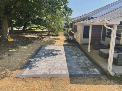 A House With A Porch And A Patio In Front Of It - Perry Hall, MD - Oakwood Landscaping LLC