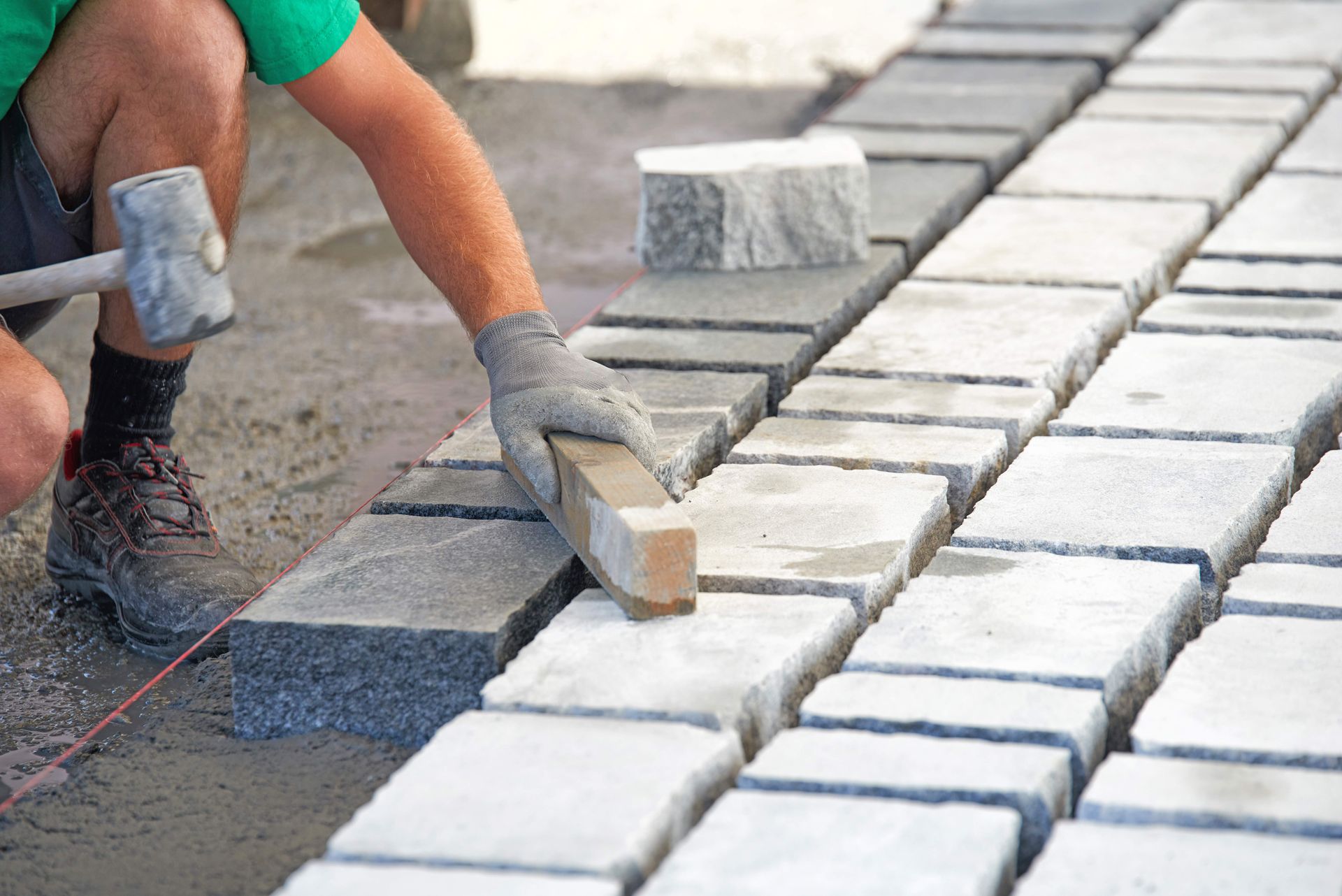 Paving worker laying stones
