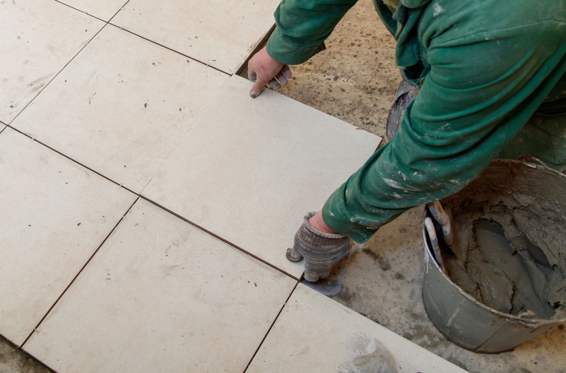 Man laying floor tiles
