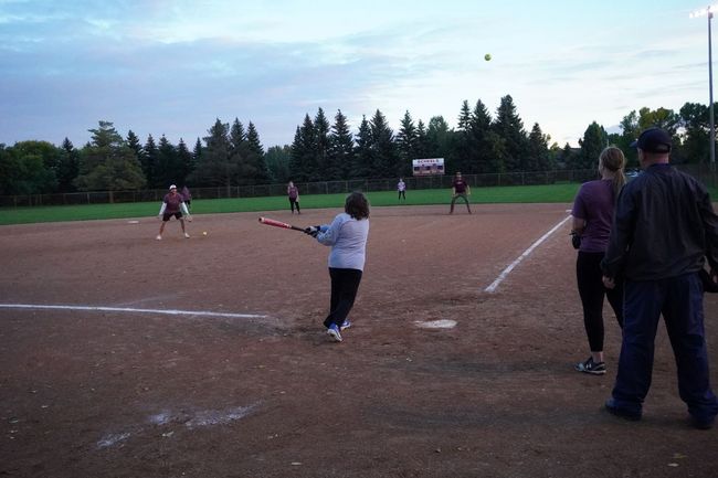 Teams playing softball in a park.