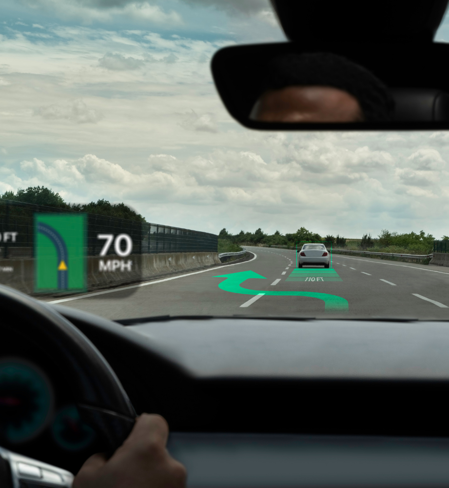 HUD displays speed and navigation on a road with a car.