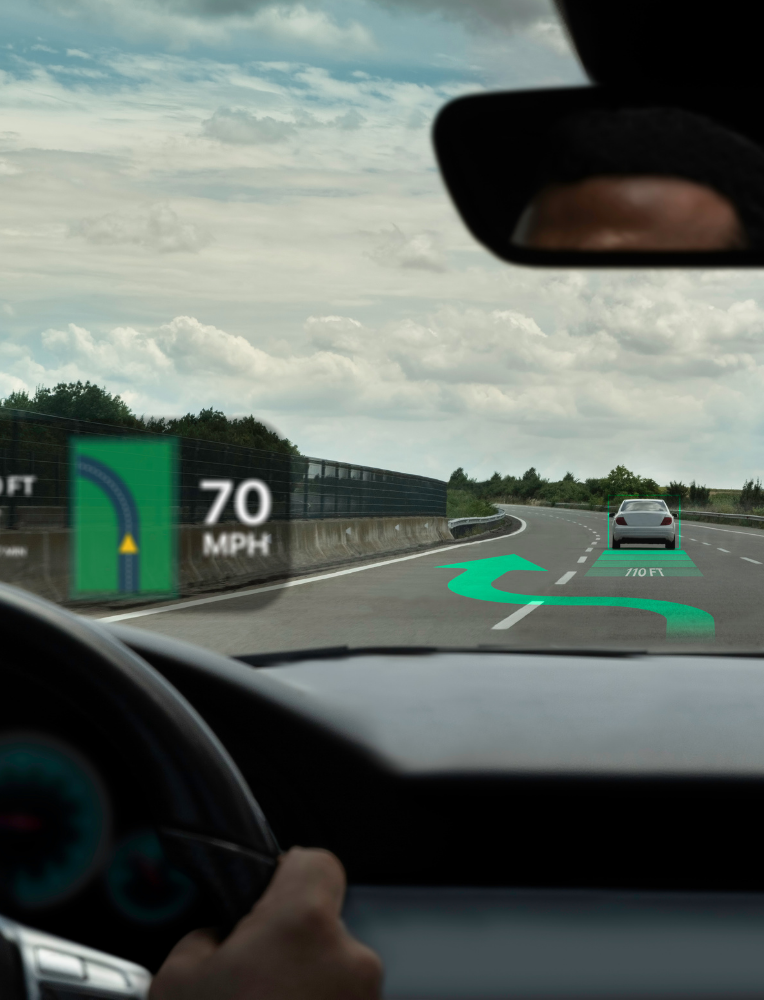 Driver’s view on a highway with lane assist graphics and a 70 MPH sign ahead