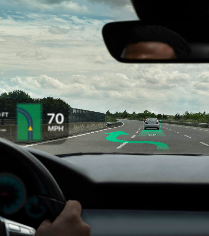 Driver’s view of a highway with a 70 mph sign and a car ahead under cloudy skies