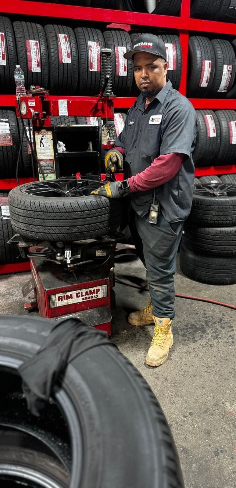 A man is working on a tire in a tire shop.