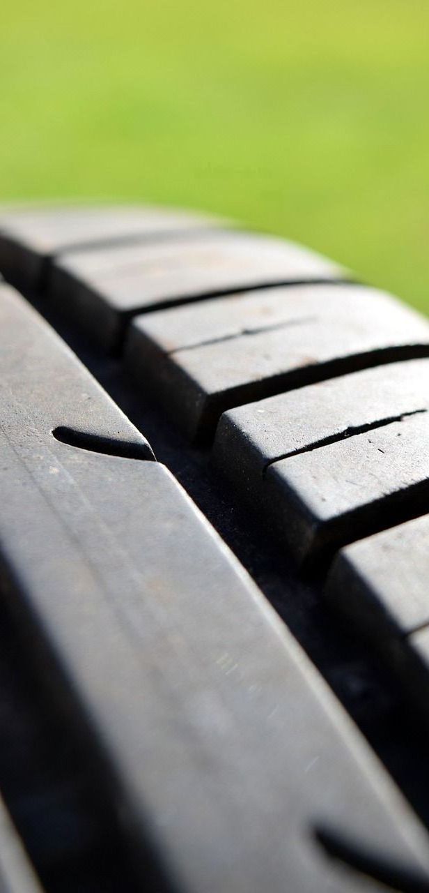 A close up of a tire with a green background