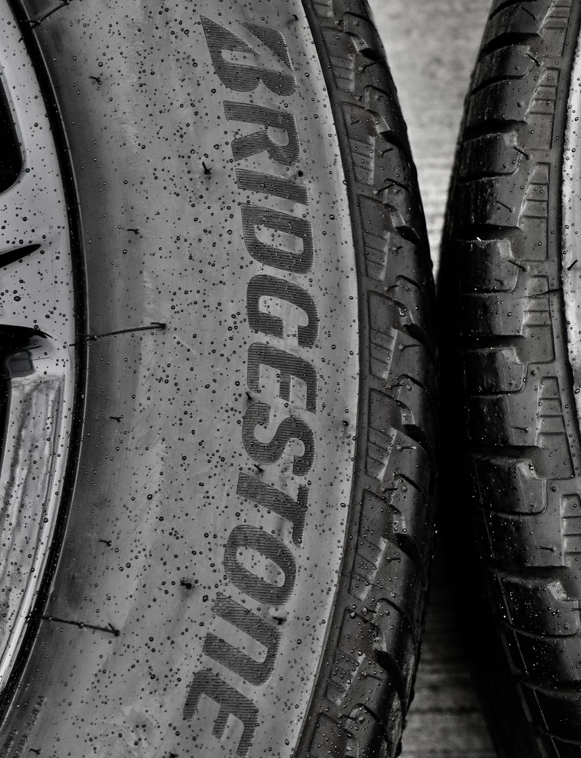 Close-up of stacked black tires, one showing the Bridgestone logo.