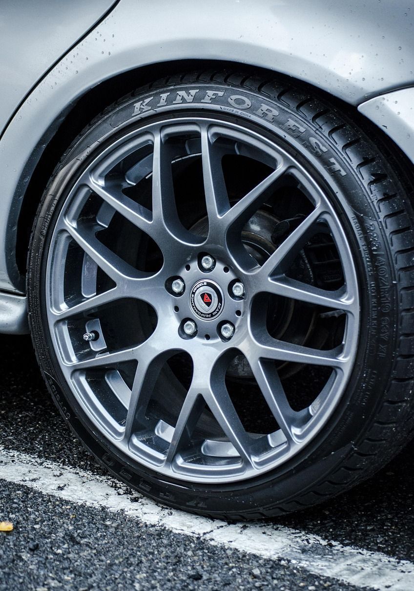 A close up of a car wheel with a tire on it.