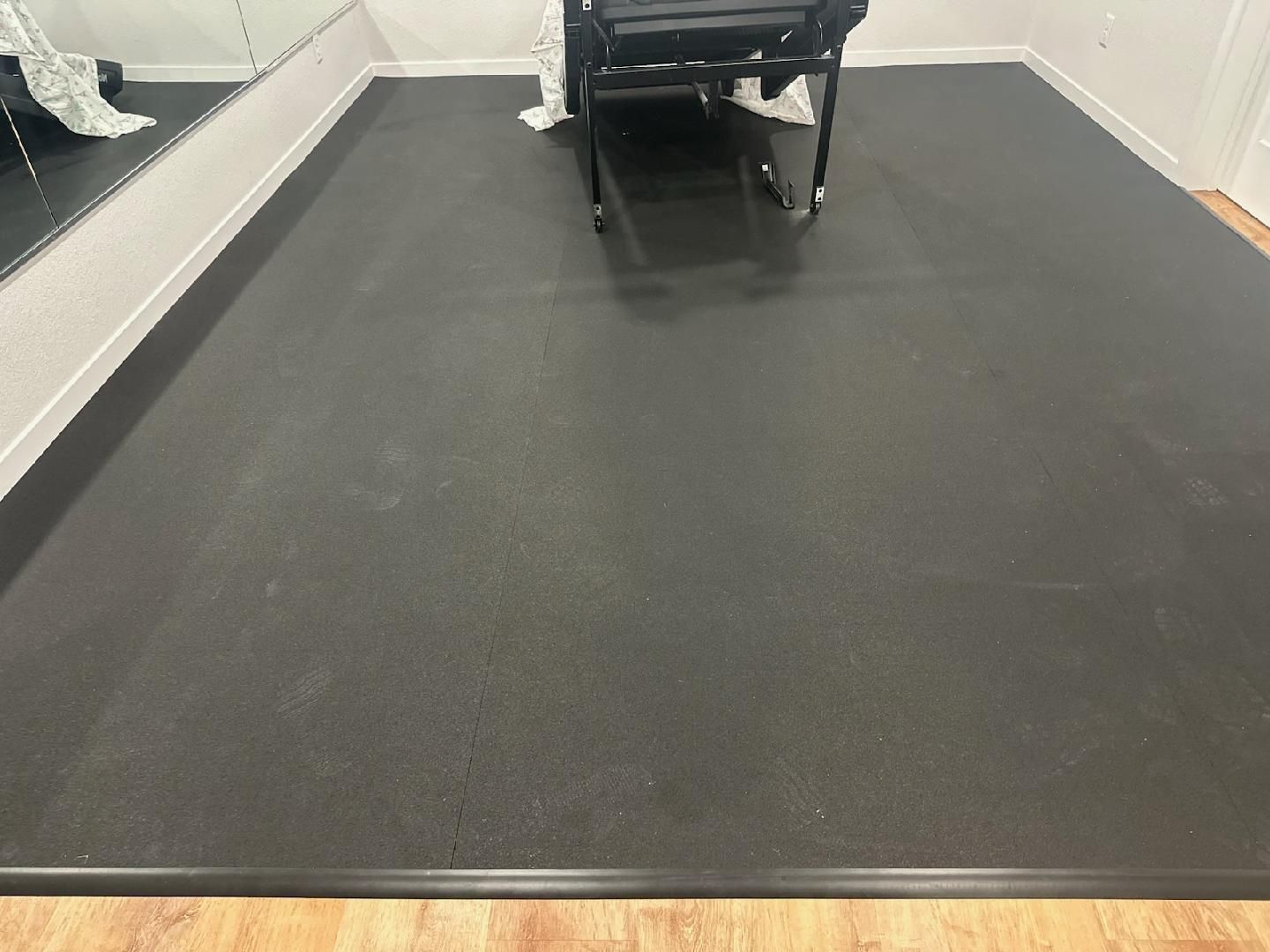 Treadmill in a gym, with a black belt and silver side rails