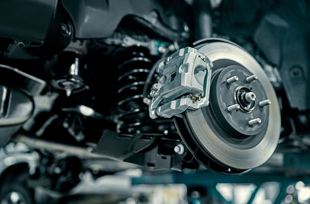 Close-up of a car brake rotor and caliper inside the wheel assembly
