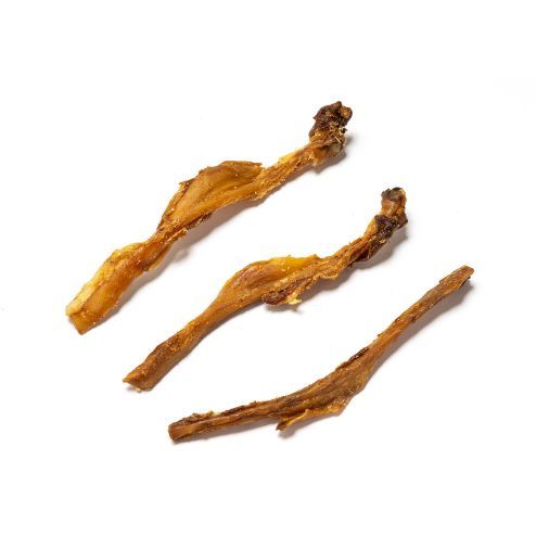 Three dried brown root or herb pieces on a white background