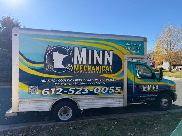 A box truck parked on a residential street with 