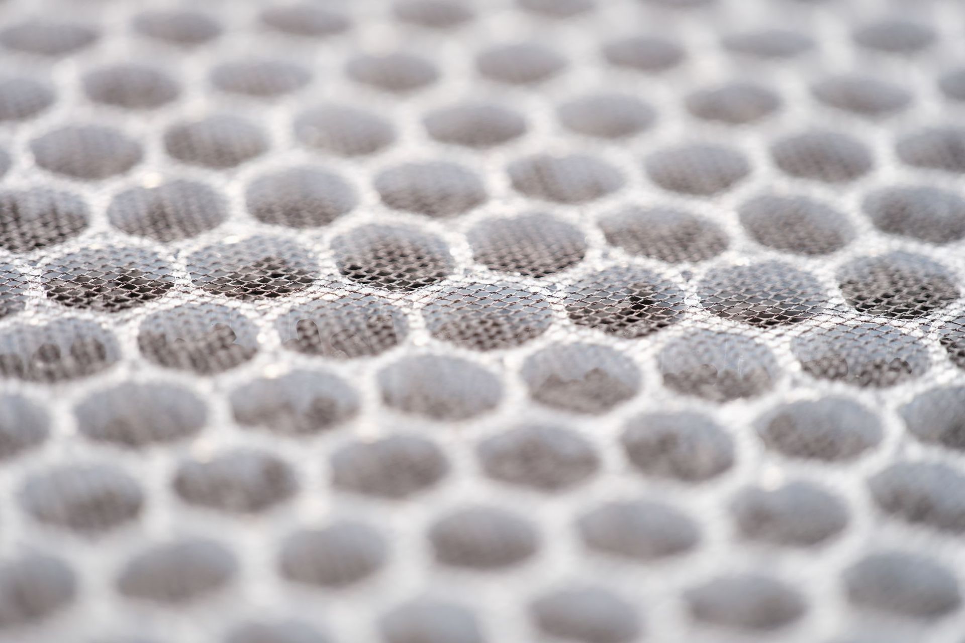 Close-up view of a gray, honeycomb-patterned fabric.