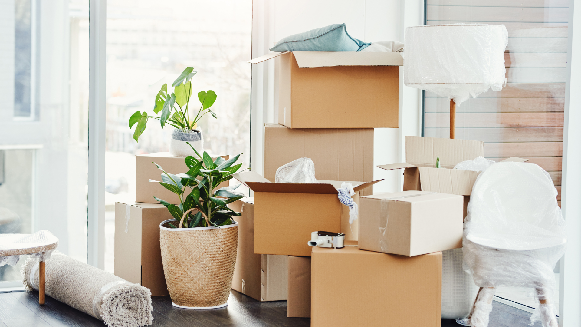 A bunch of cardboard boxes are stacked on top of each other in a room.