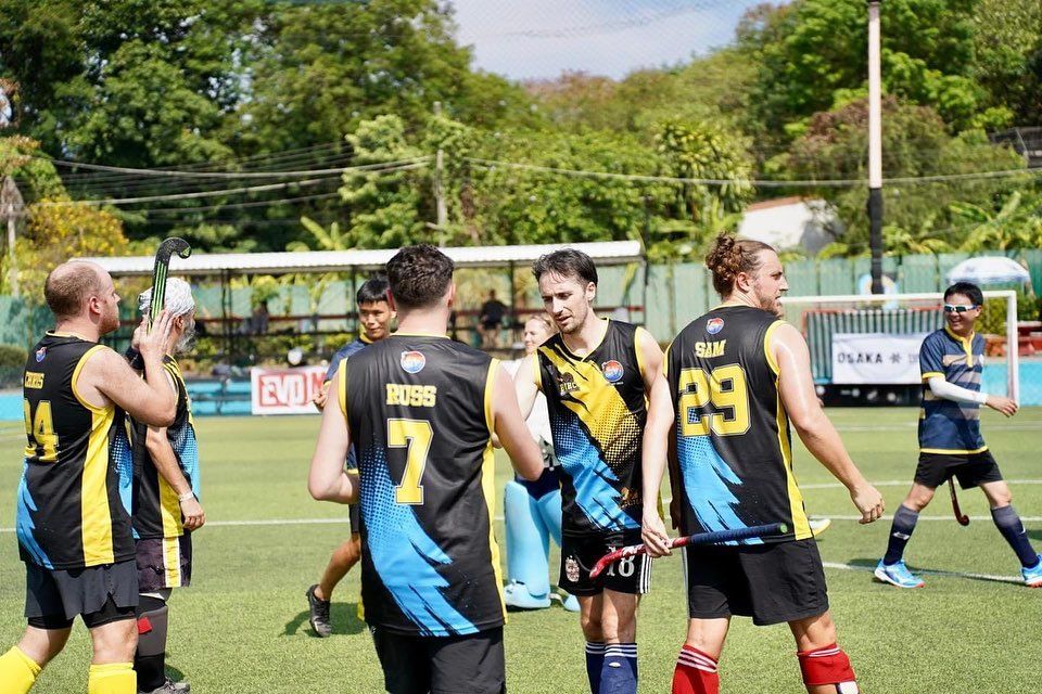 A group of soccer players are standing on a field.
