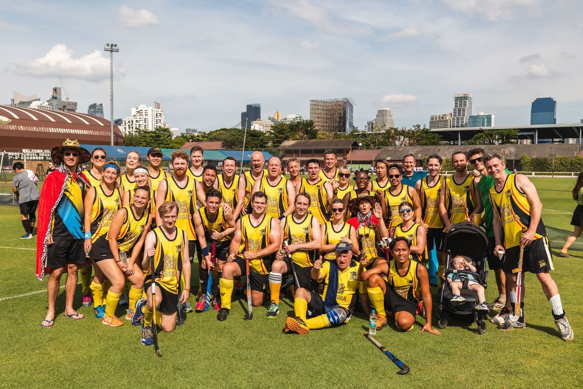 A group of people are posing for a picture on a field.