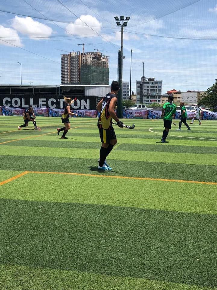 A group of people are playing soccer on a field.