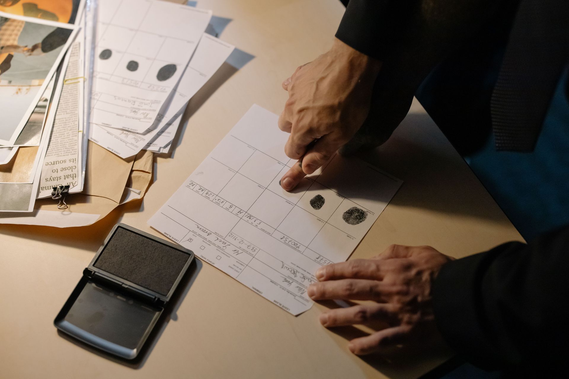Finger being prepared for traditional ink fingerprinting.