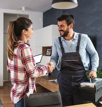 Woman Shaking Hands with Repairman | Finksburg, MD | Handyman On Call LLC