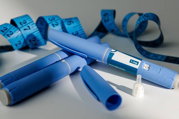 Blue GLP-1 injection pens with measuring tape, suggesting care and weight management