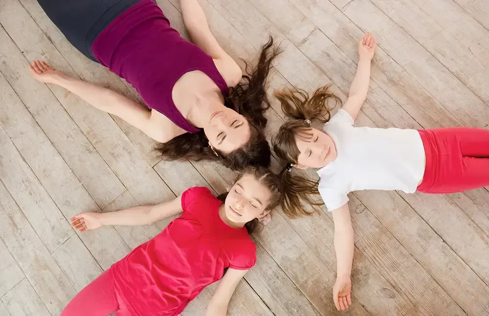 mother with daughters laying on the floor