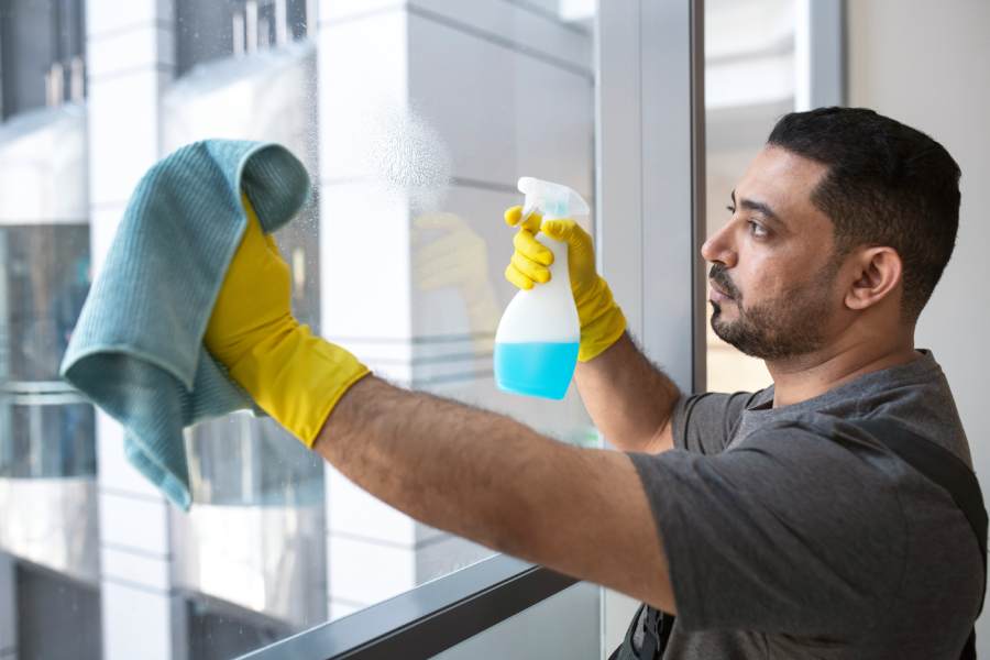 medium-shot-man-cleaning-office-window