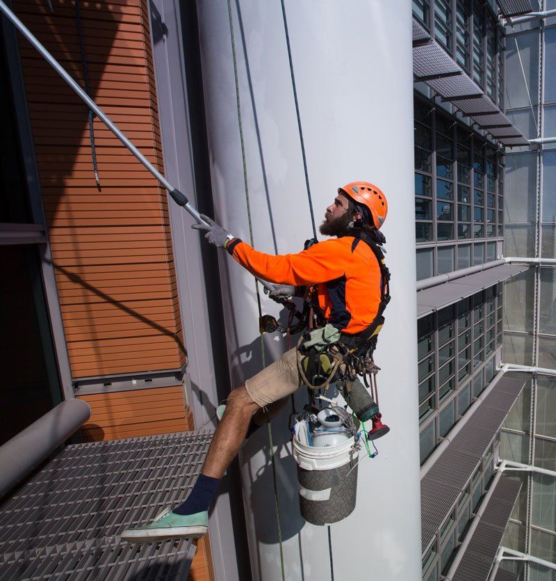 medium-shot-man-cleaning-office-window
