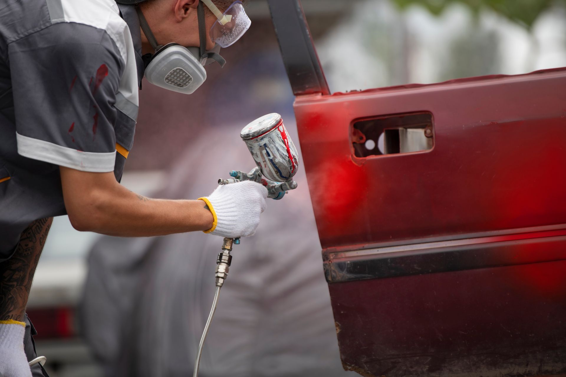 A person is polishing a white car with a machine.