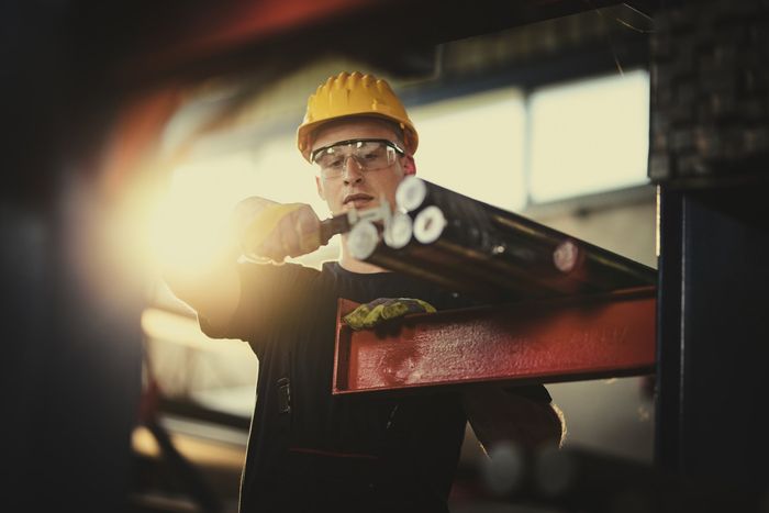 Worker Measuring Steel Tube — Quincy, IL — Abbott Supply LLC